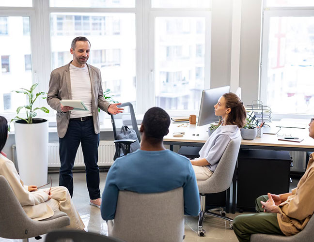 Career Coach NJ leading a group coaching session in a modern office, presenting ideas and guiding professionals on career growth and development