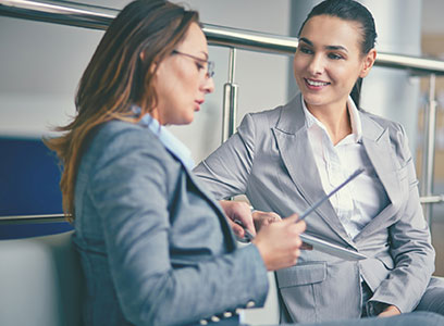 Career Coach NJ discussing career planning and reviewing documents with a client in a professional office environment